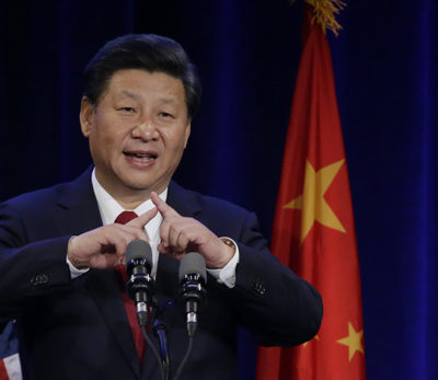 Chinese President Xi Jinping talks about how the Chinese symbol for the word "people" resembles two sticks supporting each other as he speaks Tuesday, Sept. 22, 2015, at a banquet in Seattle. Xi was in Seattle on his way to Washington, D.C., for a White House state dinner on Friday. (AP Photo/Ted S. Warren)